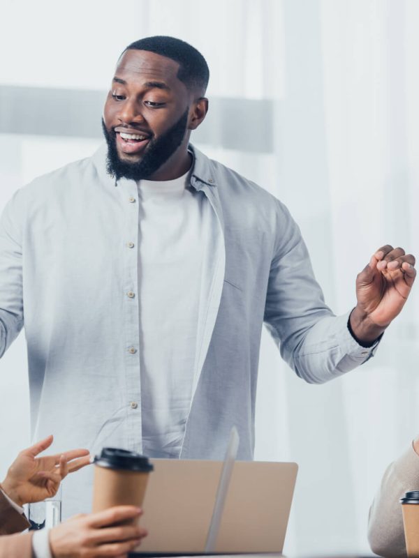 african-american-man-talking-with-colleagues-during-meeting-in-creative-agency.jpg